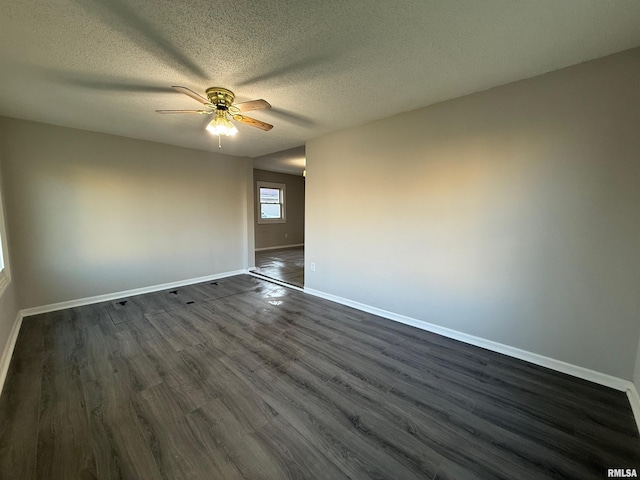 528 Cass St, East Peoria, IL 61611 - empty room with a ceiling fan, baseboards, dark wood-style floors, and a textured ceiling