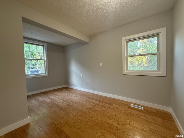 528 Cass St, East Peoria, IL 61611 - empty room with a textured ceiling, wood finished floors, and baseboards