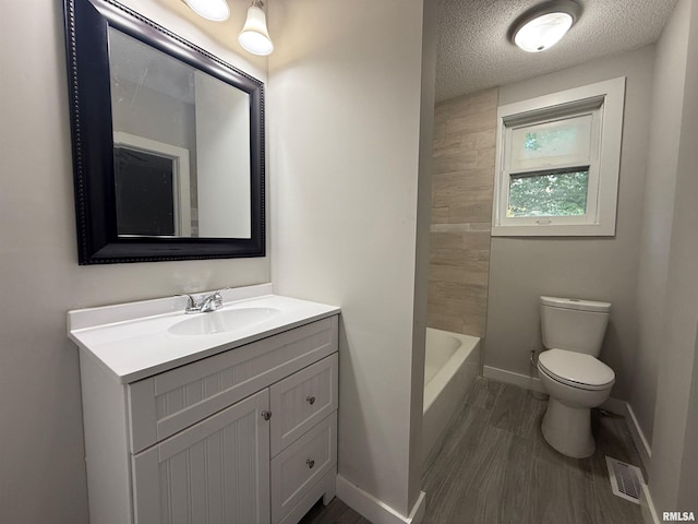 528 Cass St, East Peoria, IL 61611 - full bath with toilet, vanity, baseboards, a textured ceiling, and wood finished floors