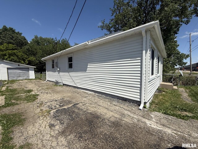 528 Cass St, East Peoria, IL 61611 - view of home's exterior featuring an outbuilding and a detached garage