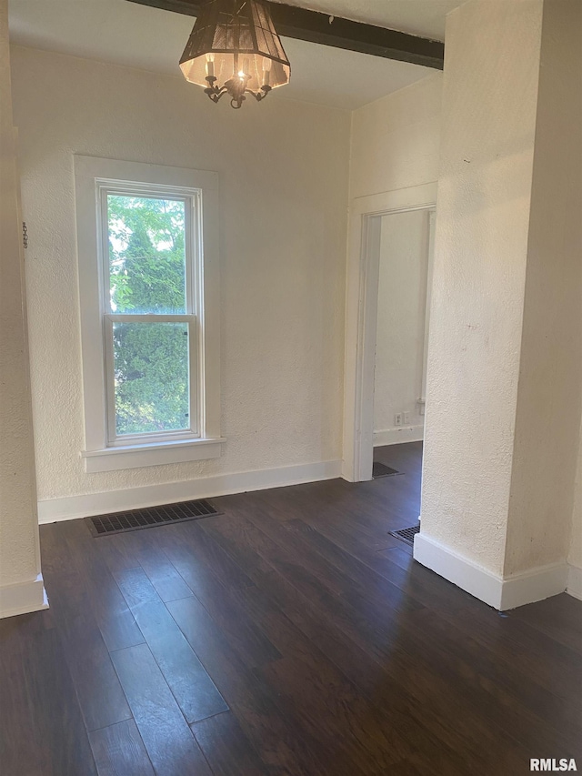 731 S Johnson St, Macomb, IL 61455 - unfurnished dining area featuring dark wood finished floors, baseboards, a chandelier, and a textured wall