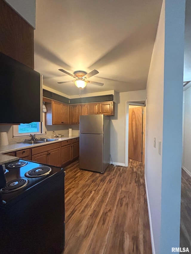 123 N Oak St, Williamsfield, IL 61489 - kitchen featuring freestanding refrigerator, black range with electric cooktop, a sink, and dark wood-style flooring