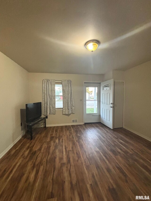 123 N Oak St, Williamsfield, IL 61489 - unfurnished living room with dark wood-style floors and baseboards