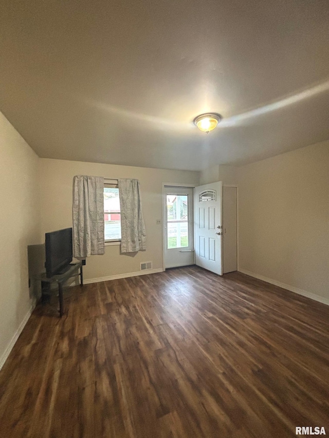 123 N Oak St, Williamsfield, IL 61489 - unfurnished living room featuring dark wood-style floors and baseboards
