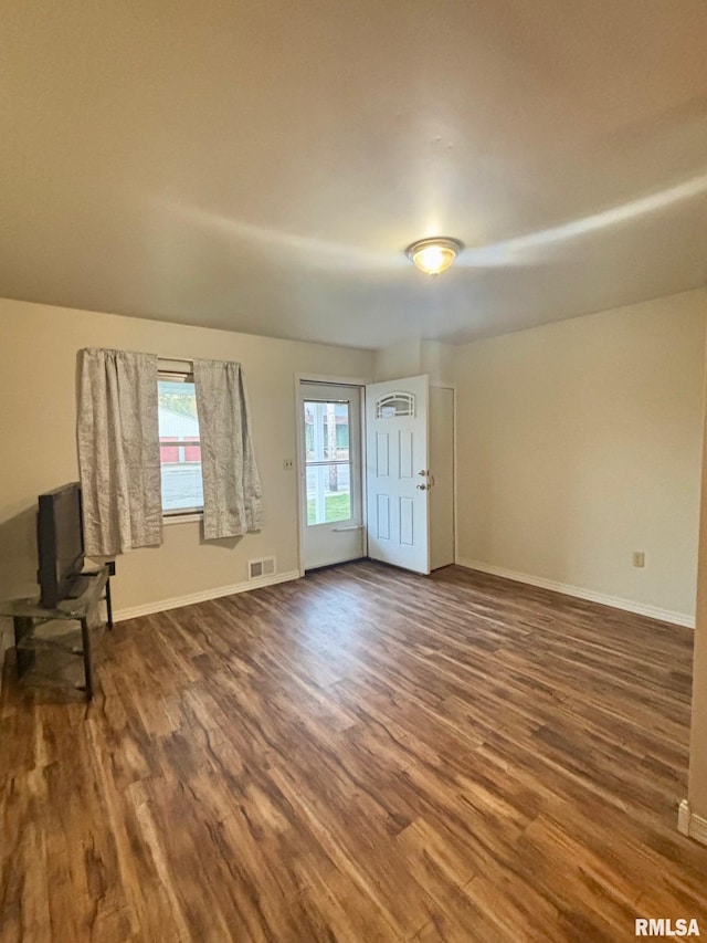 123 N Oak St, Williamsfield, IL 61489 - unfurnished living room featuring wood finished floors and baseboards