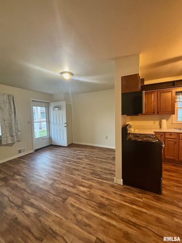 123 N Oak St, Williamsfield, IL 61489 - kitchen with open floor plan, dark wood-type flooring, baseboards, and brown cabinets