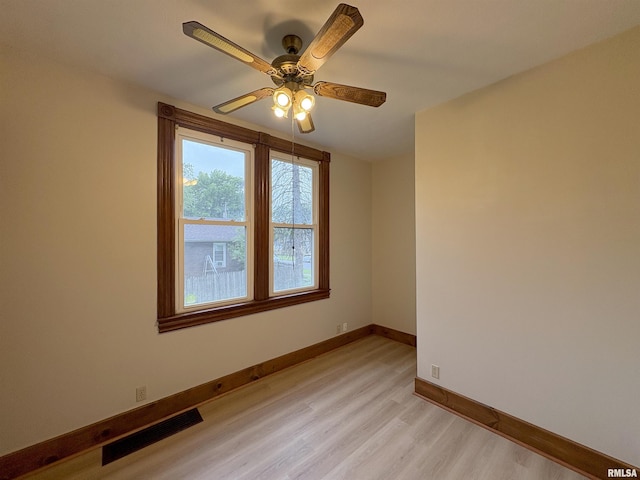 2704 N Dechman Ave, Peoria, IL 61603 - spare room with light wood-style flooring, ceiling fan, and baseboards