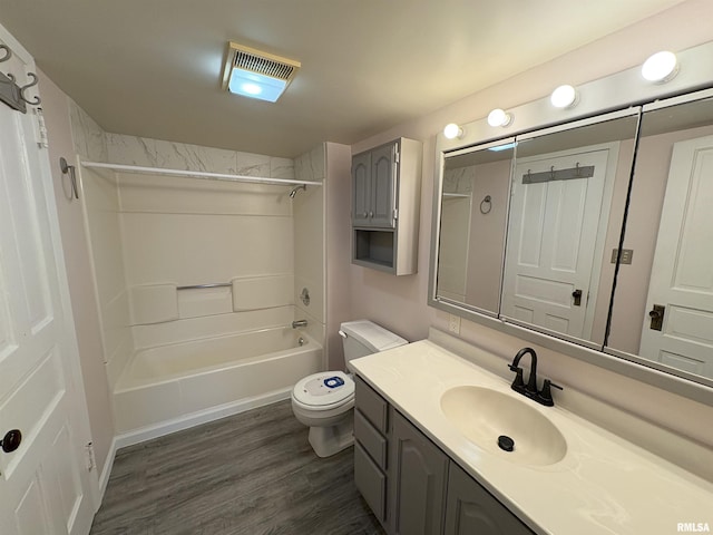 2704 N Dechman Ave, Peoria, IL 61603 - full bath with vanity, bathtub / shower combination, toilet, and wood finished floors