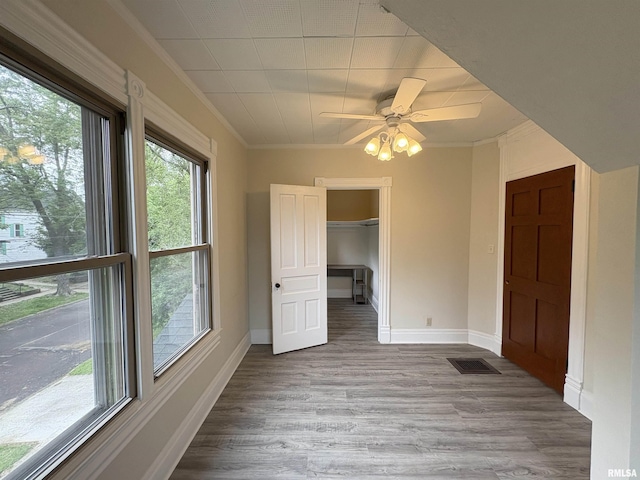 2704 N Dechman Ave, Peoria, IL 61603 - spare room featuring ornamental molding, wood finished floors, baseboards, and ceiling fan