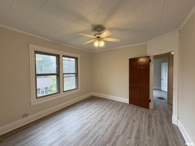 2704 N Dechman Ave, Peoria, IL 61603 - unfurnished room with crown molding, wood finished floors, baseboards, and ceiling fan