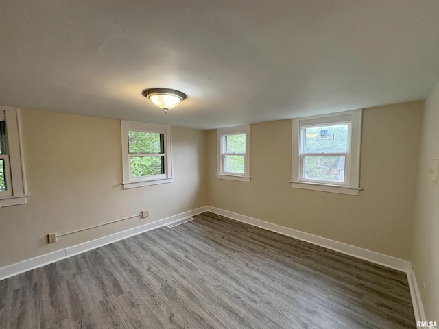 2704 N Dechman Ave, Peoria, IL 61603 - empty room featuring wood finished floors and baseboards