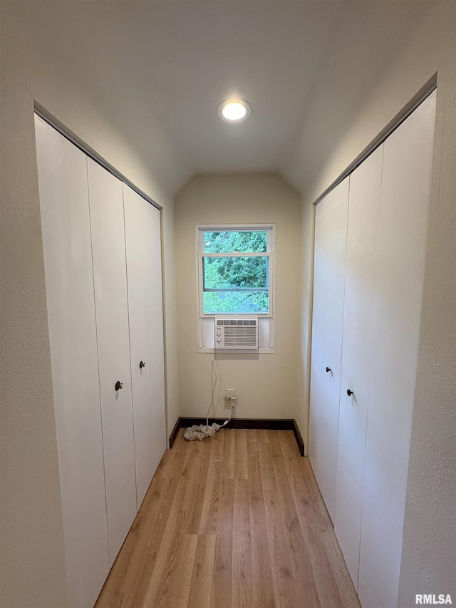 2704 N Dechman Ave, Peoria, IL 61603 - unfurnished bedroom featuring vaulted ceiling, light wood-type flooring, cooling unit, and baseboards