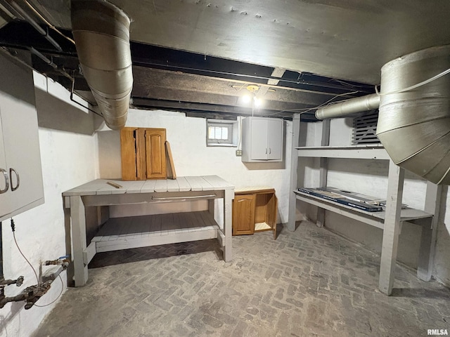 2704 N Dechman Ave, Peoria, IL 61603 - below grade area featuring a workshop area and brick patterned flooring
