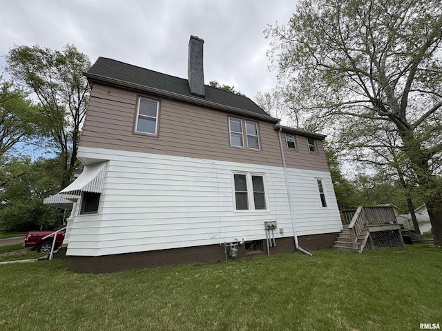 2704 N Dechman Ave, Peoria, IL 61603 - rear view of property with a chimney, a lawn, and a wooden deck