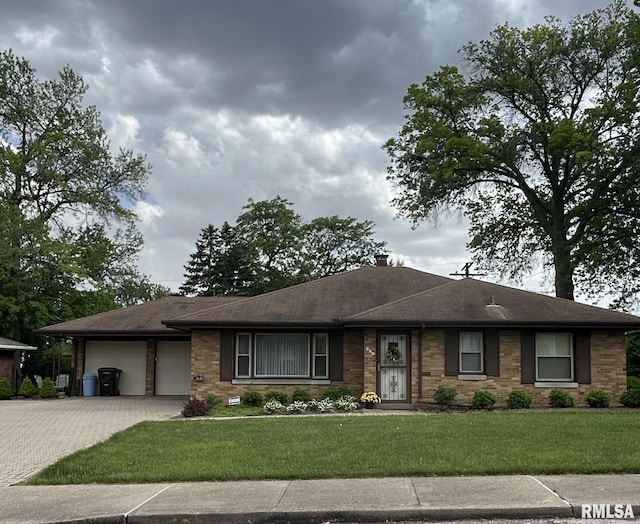 212 W Florence Ave, Peoria, IL 61604 - single story home featuring an attached garage, driveway, a front lawn, brick siding, and roof with shingles