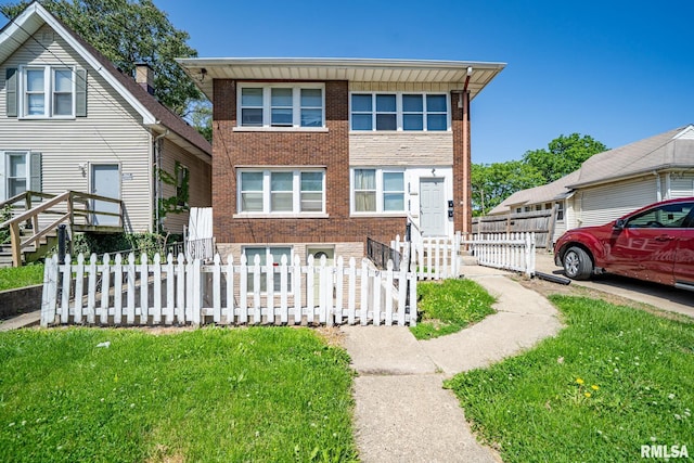 2405 N Sheridan Rd, Peoria, IL 61604 - view of front of property featuring brick siding and a fenced front yard