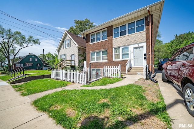 2405 N Sheridan Rd, Peoria, IL 61604 - view of property with brick siding, entry steps, and a fenced front yard