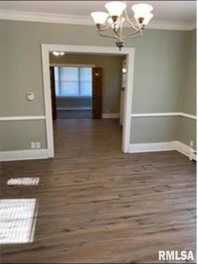 2405 N Sheridan Rd, Peoria, IL 61604 - unfurnished dining area featuring a chandelier, ornamental molding, baseboards, and wood finished floors