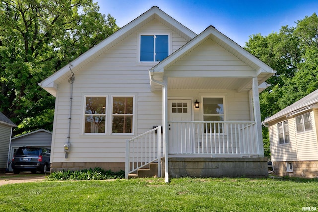 bungalow-style house featuring a porch and a front lawn