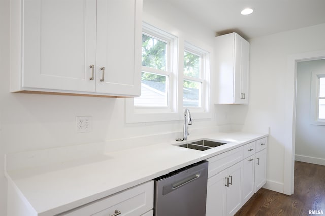 kitchen featuring dishwasher, a sink, dark wood-style floors, white cabinets, and light countertops