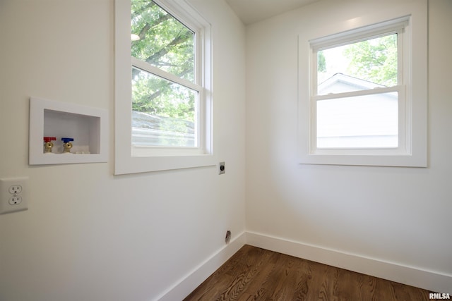 laundry room featuring hookup for an electric dryer, dark wood-style floors, hookup for a washing machine, and healthy amount of natural light