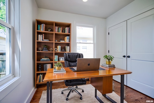 office area featuring plenty of natural light, dark wood-style flooring, and baseboards