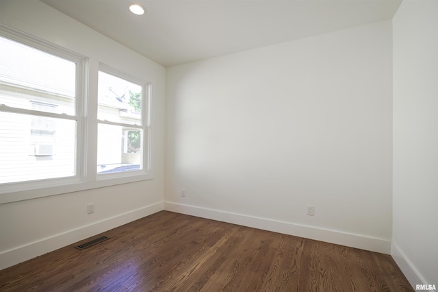 unfurnished room with baseboards, dark wood-style floors, and recessed lighting