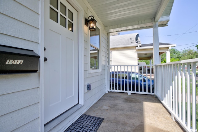 view of exterior entry featuring covered porch