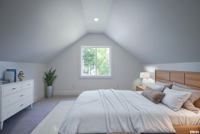 bedroom featuring lofted ceiling, carpet, and baseboards