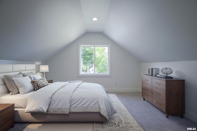 bedroom featuring lofted ceiling, light carpet, and baseboards