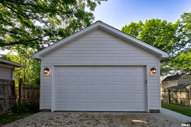 detached garage featuring fence