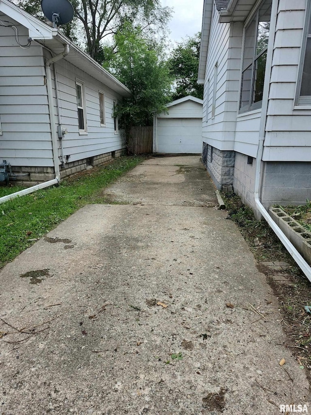 129 Pierson St, East Peoria, IL 61611 - view of property exterior with a garage and an outbuilding