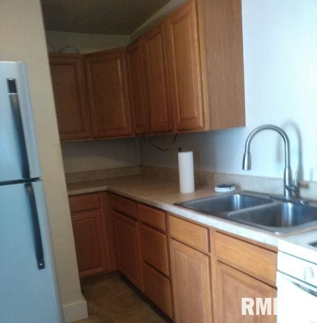 129 Pierson St, East Peoria, IL 61611 - kitchen with a sink, freestanding refrigerator, and light countertops