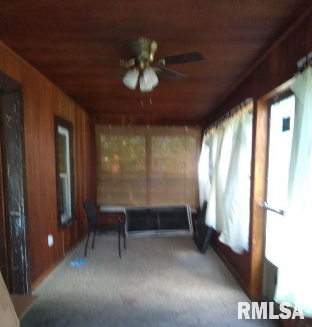129 Pierson St, East Peoria, IL 61611 - unfurnished sunroom with wooden walls, wooden ceiling, and carpet flooring