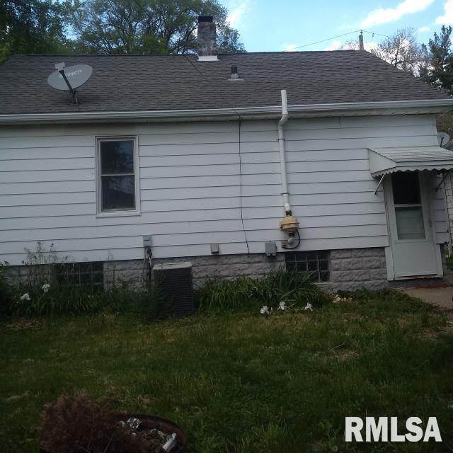 129 Pierson St, East Peoria, IL 61611 - view of side of home with a shingled roof, a chimney, and central AC unit
