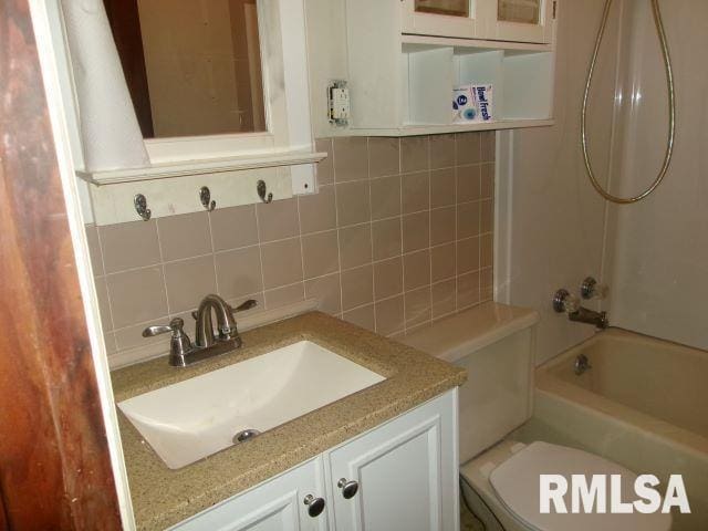 129 Pierson St, East Peoria, IL 61611 - full bath featuring decorative backsplash, vanity,  shower combination, and toilet