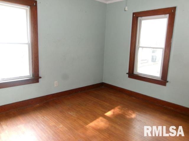 129 Pierson St, East Peoria, IL 61611 - spare room featuring wood finished floors and baseboards
