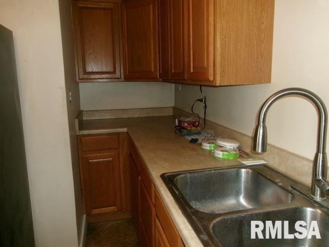 129 Pierson St, East Peoria, IL 61611 - kitchen featuring a sink, light countertops, and brown cabinetry