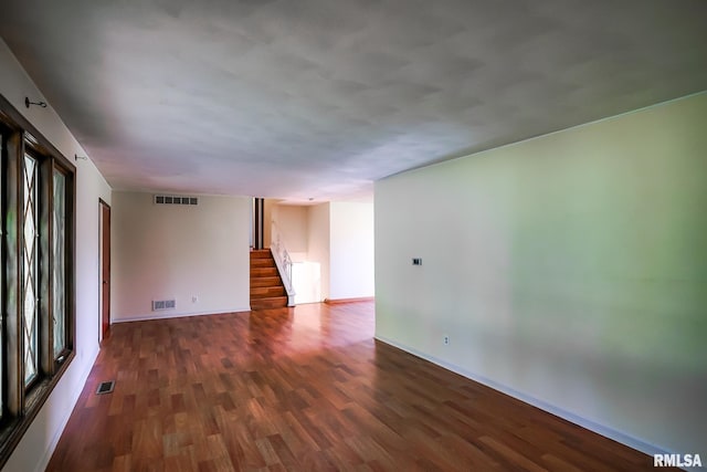 1529 W Richmar Rd, Peoria, IL 61615 - empty room with wood finished floors, stairs, and baseboards