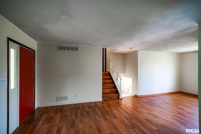 1529 W Richmar Rd, Peoria, IL 61615 - empty room featuring wood finished floors, baseboards, and stairway