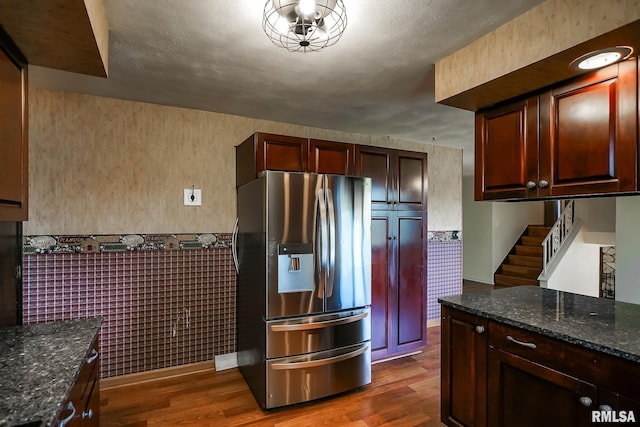 1529 W Richmar Rd, Peoria, IL 61615 - kitchen with stainless steel fridge with ice dispenser, dark wood-style floors, dark stone countertops, and a wainscoted wall