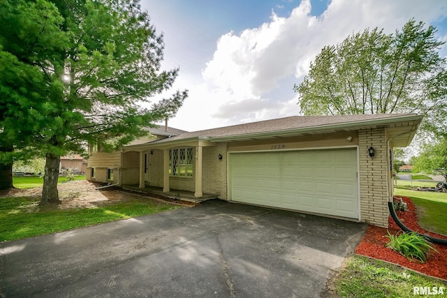 1529 W Richmar Rd, Peoria, IL 61615 - view of front facade featuring brick siding, driveway, and an attached garage