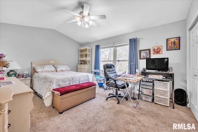 carpeted bedroom featuring vaulted ceiling, a closet, an office area, and a ceiling fan