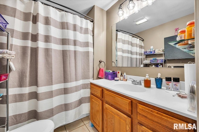 full bathroom with tile patterned flooring, vanity, and toilet