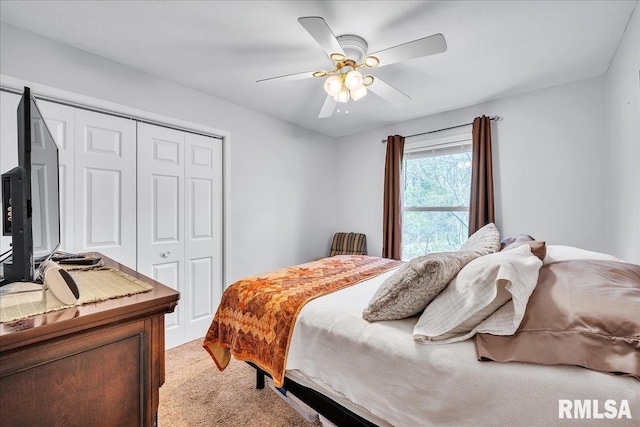 bedroom with a closet, light carpet, and ceiling fan