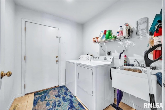 washroom with washer and dryer and light tile patterned floors