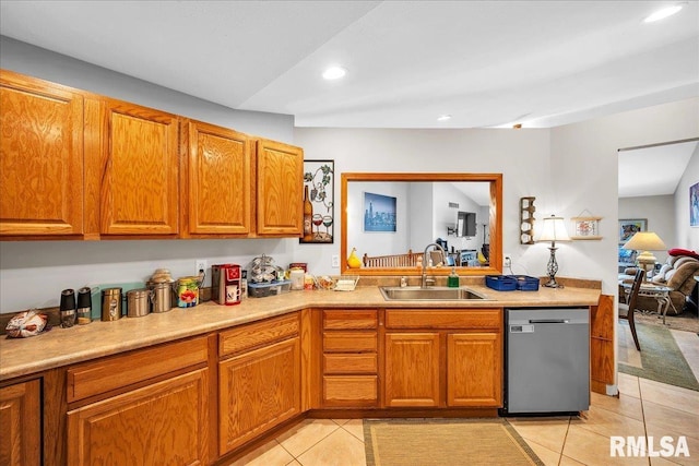 kitchen featuring dishwasher, a sink, light tile patterned flooring, brown cabinetry, and recessed lighting