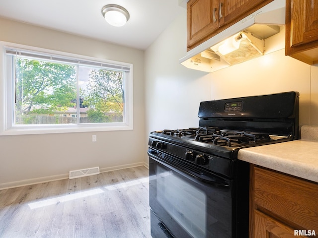 3509 S Dorothy Ct, Bartonville, IL 61607 - kitchen featuring black gas range oven, brown cabinets, and plenty of natural light