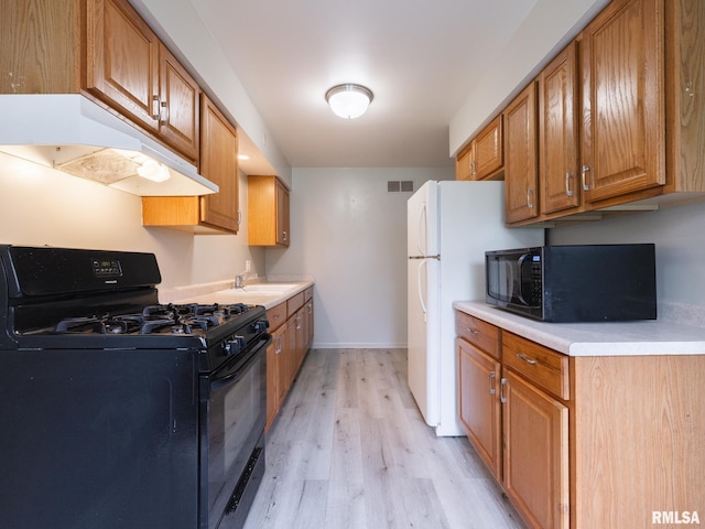 3509 S Dorothy Ct, Bartonville, IL 61607 - kitchen featuring black appliances, under cabinet range hood, light wood-style floors, light countertops, and baseboards