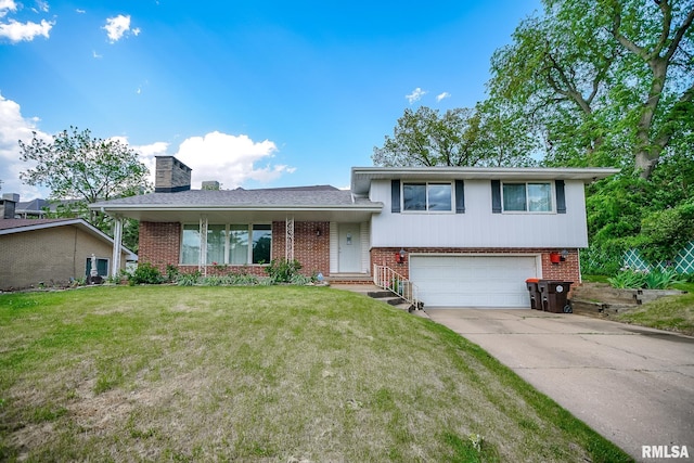 tri-level home featuring brick siding, an attached garage, a chimney, concrete driveway, and a front lawn